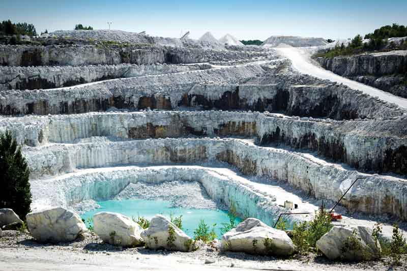 Vista de las capas rocosas de una mina de piedra de mármol blanca a cielo abierto., Mármoles Arca,The best in design, Real Estate